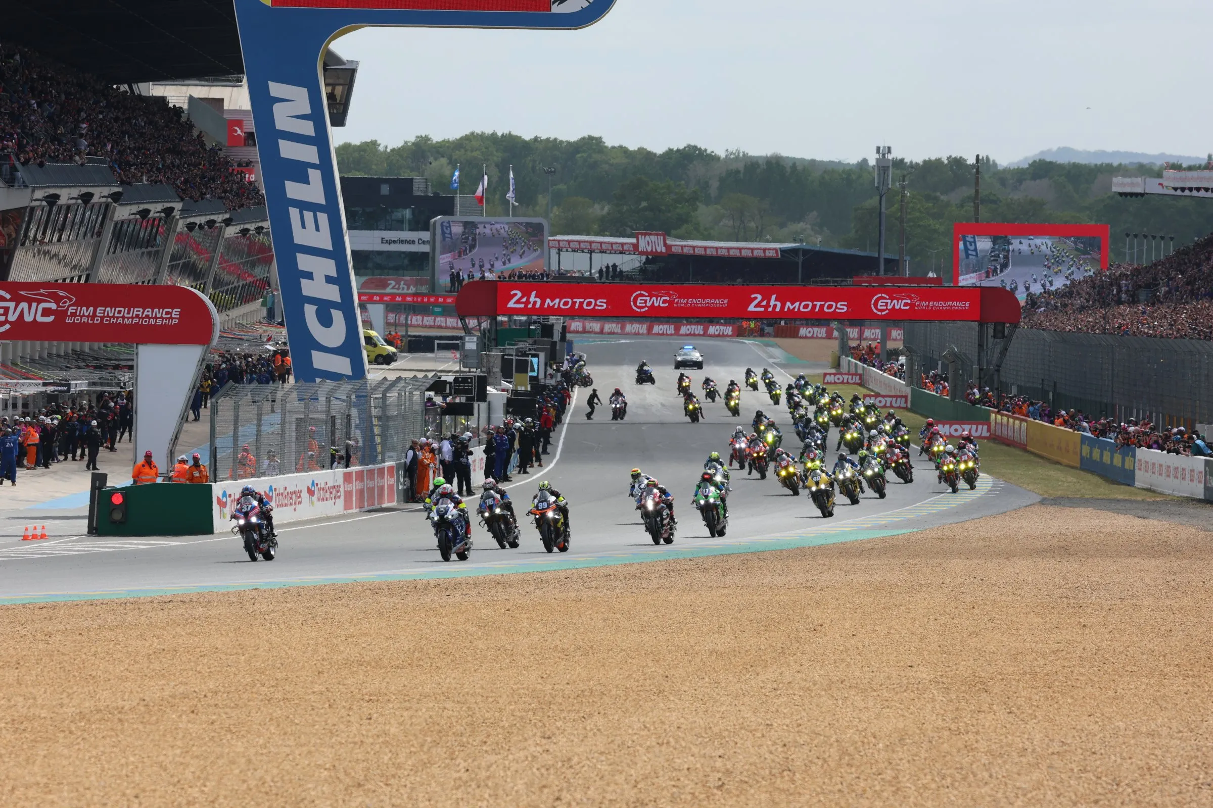 Start of the 24 Heures Motos at Le Mans, with packed grandstands